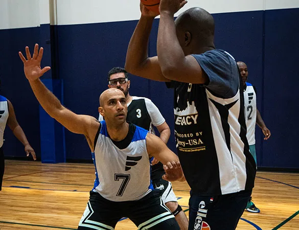 basketball player playing defense in a tournament game